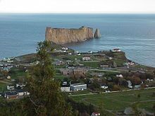 An aerial view of the village of Percé, Quebec, and its famous rock, taken from Mont-Sainte-Anne