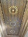 View a ceiling sculpted with roses and geometrical frames