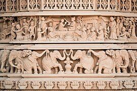 Exterior carving showing Swaminarayan ordaining Gunatitanand Swami, his first spiritual successor