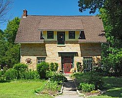 One-and-a-half-story stone house with a frame dormer