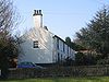 A long roughcast house in two storeys