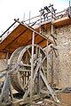 A treadwheel crane or 'squirrel cage' at Guédelon Castle.