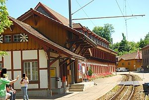 Two-story wooden building with gabled roof