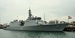 Long-grey ship anchored at a dock