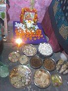 A setup for prayer on Choti Diwali along with many type of food item to do worship in front of lord mahalaxmi