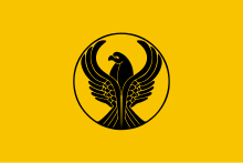 Yellow flag with a stylized black eagle in the center. The eagle's wings are spread.