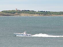 Small police boat on large body of water