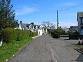 The mainstreet with the site of the old school on the right.