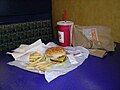 A Burger King meal including small french fries, a Whopper, Jr., Barq's Root Beer, and packets of Heinz ketchup