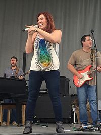 Singer Jo Dee Messina standing on a stage.