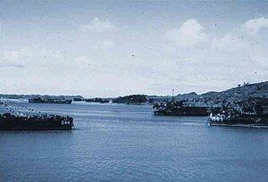 Left to right: LSM-344, LST-1074, and LST-1082 in Sasebo Harbor, Kyūshū, Japan. A Japanese seaplane base can be seen at the left center of photo.