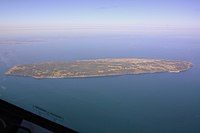 The island seen from the southeast out of an airplane window. The cliffs, the ferry dock and the various settlements and lakes are clearly visible