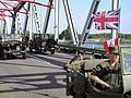 The bridge being crossed by military vehicles