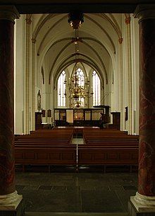 Stage and pews of a cathedral.