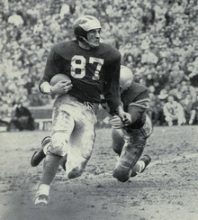 Black and white photo of Kramer rushing a football