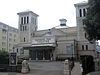 Light grey facade of a large building with "Devonshire Park Theatre" inscribed on the central face