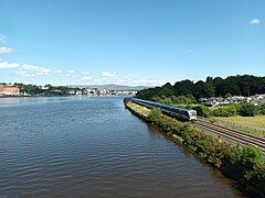 Class 400 DMU approaching the station beside the Foyle river on 22 June 2023