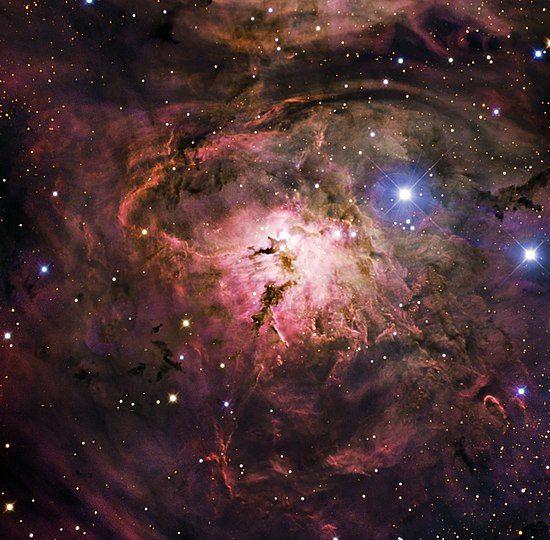 The Lagoon Nebula derives its name from the wide lagoon-shaped dark lane located in the middle of the nebula that divides it into two glowing sections. Show another