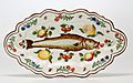 Polychrome maiolica dish with paintings of a fish, flowers and fruit, Lodi, 1751.