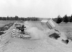 Packing crates are used to demonstrate the danger of the M72 LAW back blast