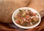 Pebre and bread is served on the table before the meal at most restaurants in Chile.