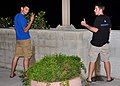 Two men urinating in public, which is often perceived to be indecent exposure