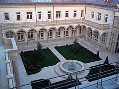 Courtyard (Curtains and chandeliers are visible in all windows.)