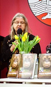 Birutė Galdikas shown speaking into a microphone