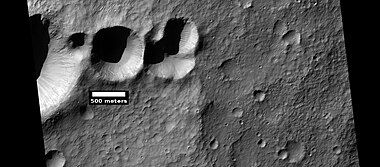 Group of craters that may have struck the surface at the same time after an asteroid broke up. If the craters were formed at different times, they would have wiped away parts of the others. Picture was taken by HiRISE, under HiWish program. Image located in Terra Cimmeria.