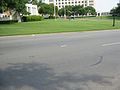 Looking in a southerly direction, with the white pergola and the knoll behind the photographer. The X on the street marks the position of JFK during the final shot. Photo taken July, 2006.