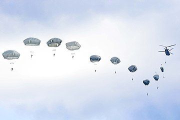 US parachutists jump from a Chinook over Germany in 2019.