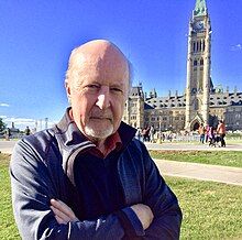 Author in Ottawa, Centre Block in background on Parliament Hill