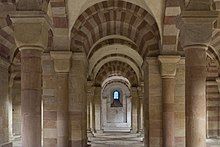 A great hall with a high arched ceiling braced with columns