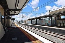 The platforms at a train station showing the footbridge