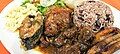 Costa Rican dinner from Puerto Limón (an area with Jamaican descendants)—gallo pinto served with various meats and accompaniments.