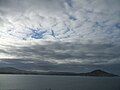 View of the Karitane harbour and seaside on a dark and cloudy day