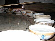 row of bowls, mostly filled with water