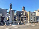 Burned-out houses after the Wennington wildfire