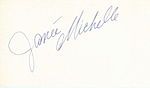 The handwritten name "Janée Michelle" in grey slanted from the bottom left to the top right all on a white background with the "M" curled under the first name