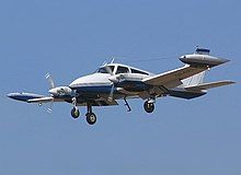 Cessna 310 plane flying through the sky