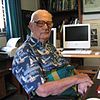 Arthur C. Clarke sitting at his desk