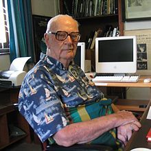 Photograph of a man sitting in a chair.