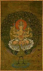 Frontal view of a deity with six arms seated on a peacock.