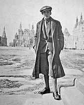 Historic photo of a young man, Palle Huld, standing before classic Russian architecture