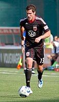 Chris Pontius dribbles a ball during a match against AFC Ajax at RFK Stadium