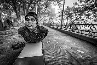 A man practicing Bhujangasana (Cobra Pose) Yoga at Uzan Bazar Riverfront Park, Guwahati, India.