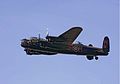 Color image of a Lancaster with its camouflage scheme upper carriage and flat black undercarriage