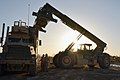 A CLB-4 handler loads a container onto an AMK31 truck at FOB Edinburgh on March 13, 2012, during retrograde operations.