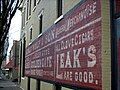 A vintage building ad on the east side of North Water St between East Main and Oak Streets in Downtown Silverton