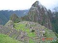 Machu Picchu ruins, Huayna Picchu peak in the background.